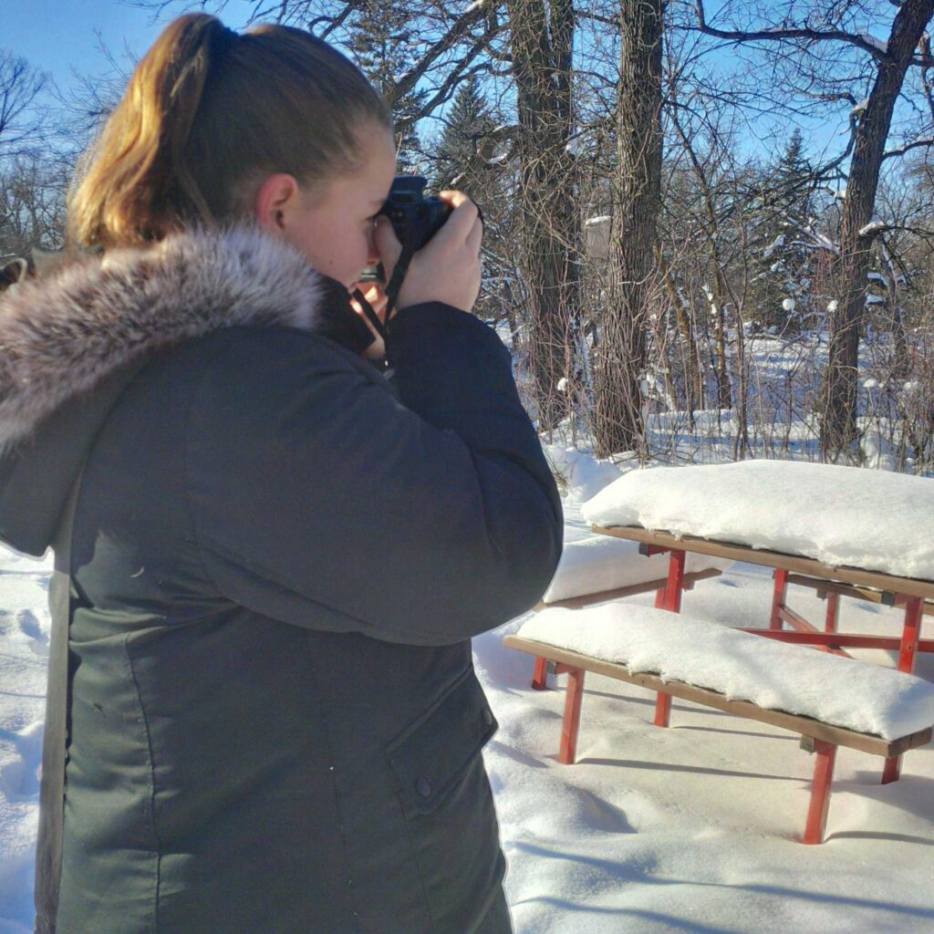 Young Manitoba photographer with her first DSLR camera, beginning her photography journey.