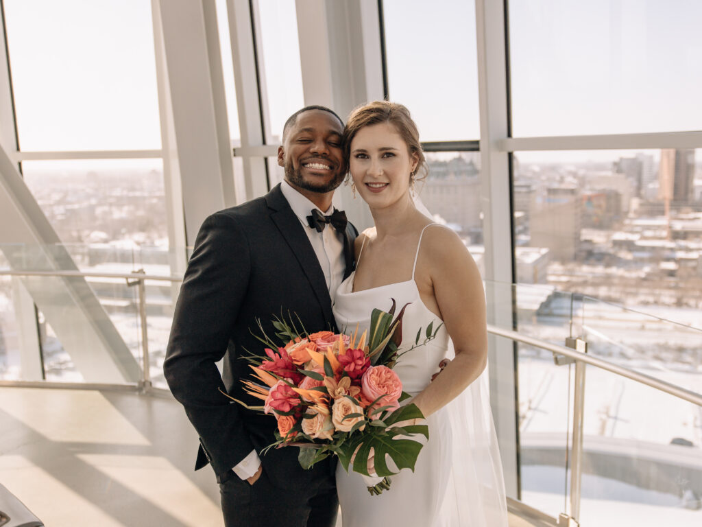 Bride and groom smiling at the camera during their Winnipeg wedding captured by Manitoba photographer.
