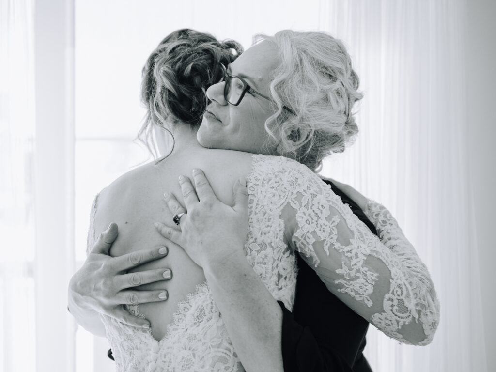Mother of the bride holding back tears during a Winnipeg wedding photographed by Manitoba photographer.